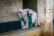 Health workers wearing protective equipment disinfect the isolation area for Ebola patients at the General Referral Hospital of Mongbwalu in Mongbwalu, Democratic Republic of Congo, on May 23, 2026. Ebola continues to spread in Democratic Republic of Congo, where the first cases of transmission were reported in the eastern province of South Kivu, while the health response is struggling to get organized and has given rise to scenes of chaos in Ituri province, the epicenter of the epidemic.