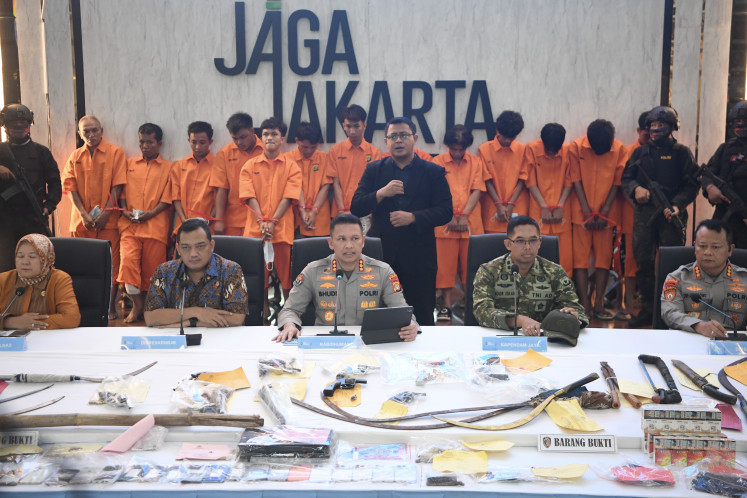 Jakarta Police spokesperson Sr. Comr. Budi Hermanto (center), accompanied by director for general crimes Sr. Comr. Iman Imanuddin (second left) and Jakarta Military Command (Kodam Jaya) spokesperson Lt. Col. Noor Ishak (second right), speaks during a press briefing about street crimes and violent robbery cases, at the Jakarta Police headquarters on May 22, 2026.