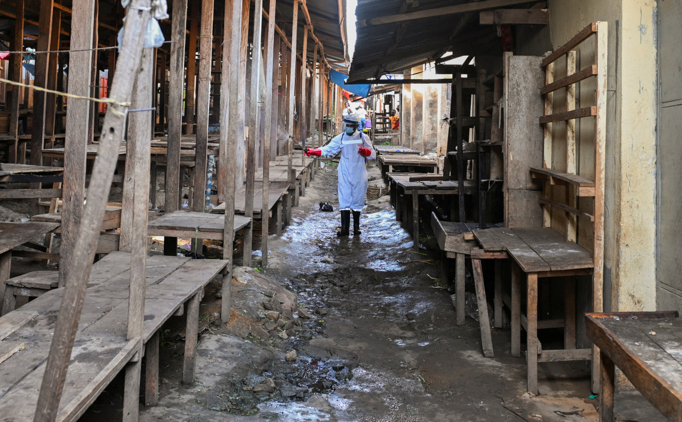 A sanitation worker from the Bunia city government sprays chlorine on May 23, 2026, at the central market to limit the risk of the spread of the Ebola virus, as authorities intensify efforts to contain a new Ebola outbreak involving the Bundibugyo strain, in Bunia, Ituri province, Democratic Republic of Congo.