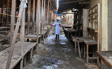 A sanitation worker from the Bunia city government sprays chlorine on May 23, 2026, at the central market to limit the risk of the spread of the Ebola virus, as authorities intensify efforts to contain a new Ebola outbreak involving the Bundibugyo strain, in Bunia, Ituri province, Democratic Republic of Congo.