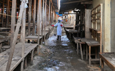A sanitation worker from the Bunia city government sprays chlorine on May 23, 2026, at the central market to limit the risk of the spread of the Ebola virus, as authorities intensify efforts to contain a new Ebola outbreak involving the Bundibugyo strain, in Bunia, Ituri province, Democratic Republic of Congo.