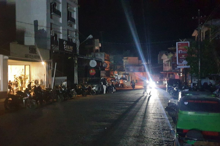 A store in Padangsidimpuan city, North Sumatra, emits generator-powered light on May 22, as the street lies shrouded in darkness. The blackout affected almost all of provinces on mainland Sumatra Island. Electricity company PT PLN said electricity was normal again on Sunday.