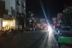 A store in Padangsidimpuan city, North Sumatra, emits generator-powered light on May 22, as the street lies shrouded in darkness. The blackout affected almost all of provinces on mainland Sumatra Island. Electricity company PT PLN said electricity was normal again on Sunday.