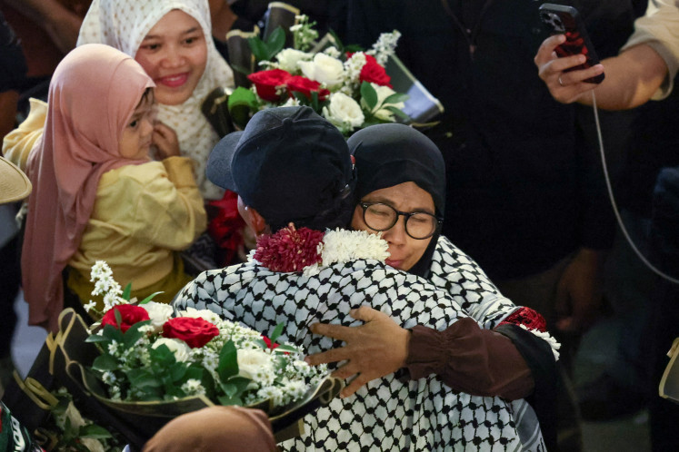 One of the Indonesian members of the Gaza-bound Global Sumud Flotilla, who were detained by Israeli forces after the flotilla's vessels were intercepted in international waters of the Mediterranean Sea, is embraced upon arrival at Soekarno-Hatta International Airport in Tangerang, May 24, 2026.