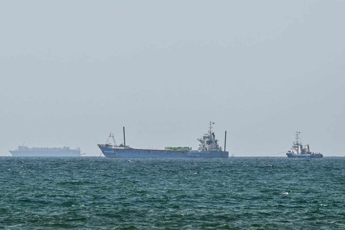 Vessels are anchored off the coast of Sharjah in the United Arab Emirates on May 21, 2026. Iran's new body overseeing the Strait of Hormuz said its claimed area of control extends to Emirati waters, drawing a sharp rebuke from the Gulf neighbor. Traffic through Hormuz, a vital global shipping conduit, has come under Iranian control since the outbreak of war with Israel and the United States on February 28.