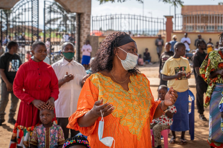 A Catholic prays while wearing a mask following local authorities&rsquo; instructions to limit the spread of the Ebola outbreak in eastern Democratic Republic of the Congo during a mass at Bunia Cathedral in Bunia on May 24, 2026. Officials in the DRC updated the death toll from the Ebola outbreak to 204 on May 23, 2026, hours after the Red Cross said three volunteers had died there and Uganda confirmed three new Ebola cases.