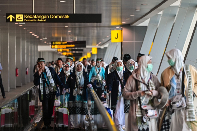 Pilgrims walk to their gate before heading to the holy city of Mecca, Saudi Arabia, to perform the annual haj pilgrimage, at Juanda International Airport in Sidoarjo, East Java, on April 22, 2026.