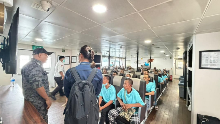A Malaysian Maritime Enforcement Agency officer (left) talks with a diplomat from the Indonesian Consulate General in Johor Bahru (right) during the repatriation of Indonesians to Batam Center Port in Batam, Riau Islands, in this undated picture released on May 25, 2026. In total, the consulate general facilitated the repatriation of 190 people, including four senior citizens and four children.