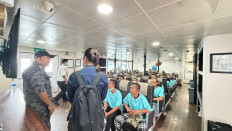 A Malaysian Maritime Enforcement Agency officer (left) talks with a diplomat from the Indonesian Consulate General in Johor Bahru (right) during the repatriation of Indonesians to Batam Center Port in Batam, Riau Islands, in this undated picture released on May 25, 2026. In total, the consulate general facilitated the repatriation of 190 people, including four senior citizens and four children.