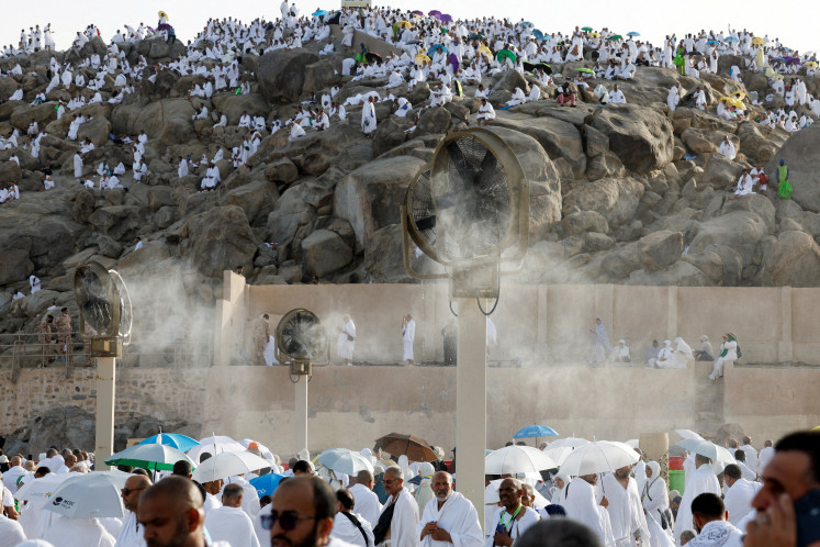 Muslim pilgrims gather near misting fans at Mount of Mercy on the plain of Arafat during the annual haj pilgrimage, outside the holy city of Mecca, Saudi Arabia, May 26, 2026.