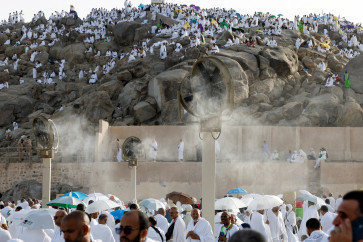 Muslim pilgrims gather near misting fans at Mount of Mercy on the plain of Arafat during the annual haj pilgrimage, outside the holy city of Mecca, Saudi Arabia, May 26, 2026.