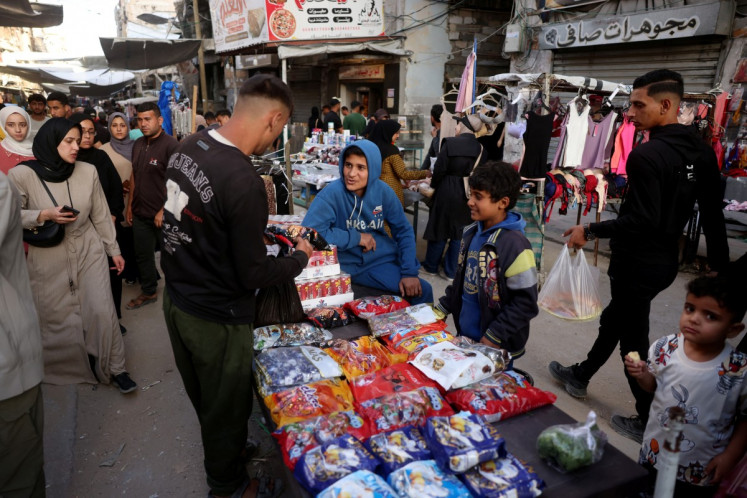 Palestinians shop on the eve of the Muslim holiday of Idul Adha, or the feast of sacrifice, marking the end of the Haj pilgrimage, in Khan Yunis in southern Gaza Strip on May 26, 2026. Idul Adha marks the end of the haj pilgrimage to Mecca.