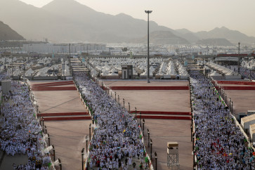 Muslim pilgrims walk on the first day of the stoning of the devil ritual, during the annual haj pilgrimage, in Mina, Saudi Arabia, on May 27, 2026.