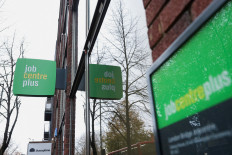 Signs are seen outside a job center in Borough, in London on Dec. 1, 2024.