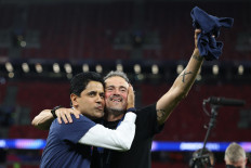 Paris Saint Germain's Qatari president Nasser al-Khelaifi (left) and Paris Saint-Germain's Spanish head coach Luis Enrique celebrate after winning the UEFA Champions League final football match between Paris Saint-Germain (PSG) and Arsenal FC at the Puskas Arena in Budapest on May 30, 2026. 