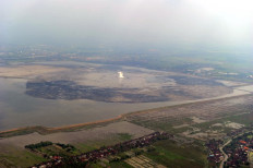 This picture taken on May 26, 2010 shows an aerial view of the Lapindo mud volcano and the mud it has spewed in proximity to surrounding villages in Porong, Sidoarjo district, on East Java.