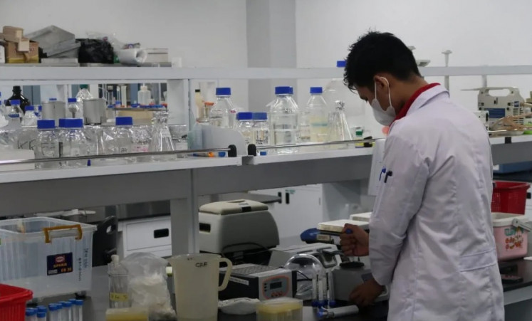 A National Research and Innovation Agency (BRIN) researcher works in a laboratory at Soekarno Science and Technology Zone in Cibinong, West Java, on July 5, 2023.