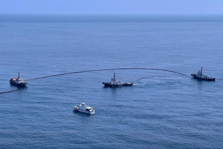 This handout from the Royal Thai Navy taken and released on January 27, 2022 shows the clean-up operation underway for a crude oil spill caused by a leak from an undersea pipeline owned by Star Petroleum Refining Public Company Limited in the Gulf of Thailand, near Rayong. 