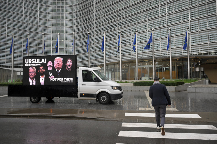 Campaigners from People vs Big Tech, WeMove Europe, and EDRi display a mobile billboard urging Commission President to stand up to Trump and Big Tech and defend Europe&rsquo;s digital laws, in front of the EU headquarters in Brussels on November 19, 2025.