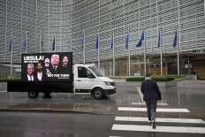 Campaigners from People vs Big Tech, WeMove Europe, and EDRi display a mobile billboard urging Commission President to stand up to Trump and Big Tech and defend Europe&rsquo;s digital laws, in front of the EU headquarters in Brussels on November 19, 2025.