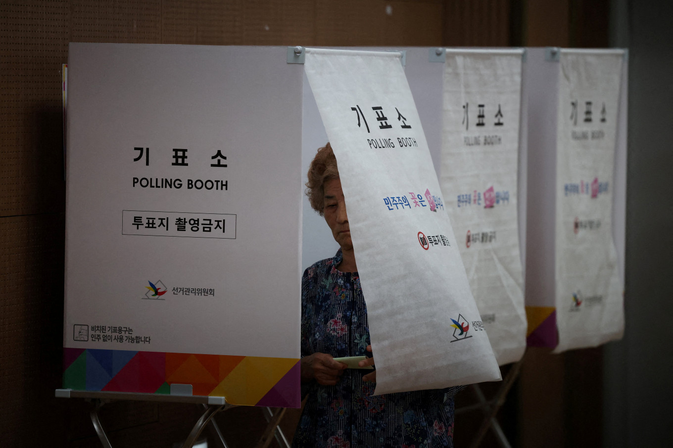 A woman leaves a voting booth during the local elections at a polling station in Seoul, South Korea, June 3, 2026.