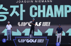 Chilean golfer Joaquin Niemann (center) celebrates with the trophy after winning LIV Golf-Korea on May 31 at Asiad Country Club in Busan, South Korea, alongside United States golfers Talor Gooch (left), who finished runner-up, and Bryson DeChambeau, who placed third.