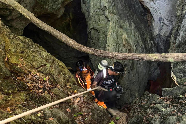 This handout image released by Metta Tham Rescue Kalasin on May 26, 2026 shows rescue workers inside a cave in Xaisomboun province in Laos. Five of seven people trapped in a flooded cave for a week in Laos were found alive on May 27, Laotian and Thai rescuers said.
