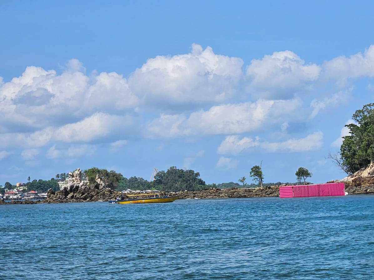 A container (right) is seen ashore on June 6, 2026, on Sambu Kecil Island, northwest of Batam Island, Riau Islands, after falling from a container vessel which sunk in Singapore Strait. The Tanzanian-flagged MV Golden Star I sunk after reporting severe leakage on the evening of June 5, 2026, and the 107 containers it carried were thrown into the open sea.