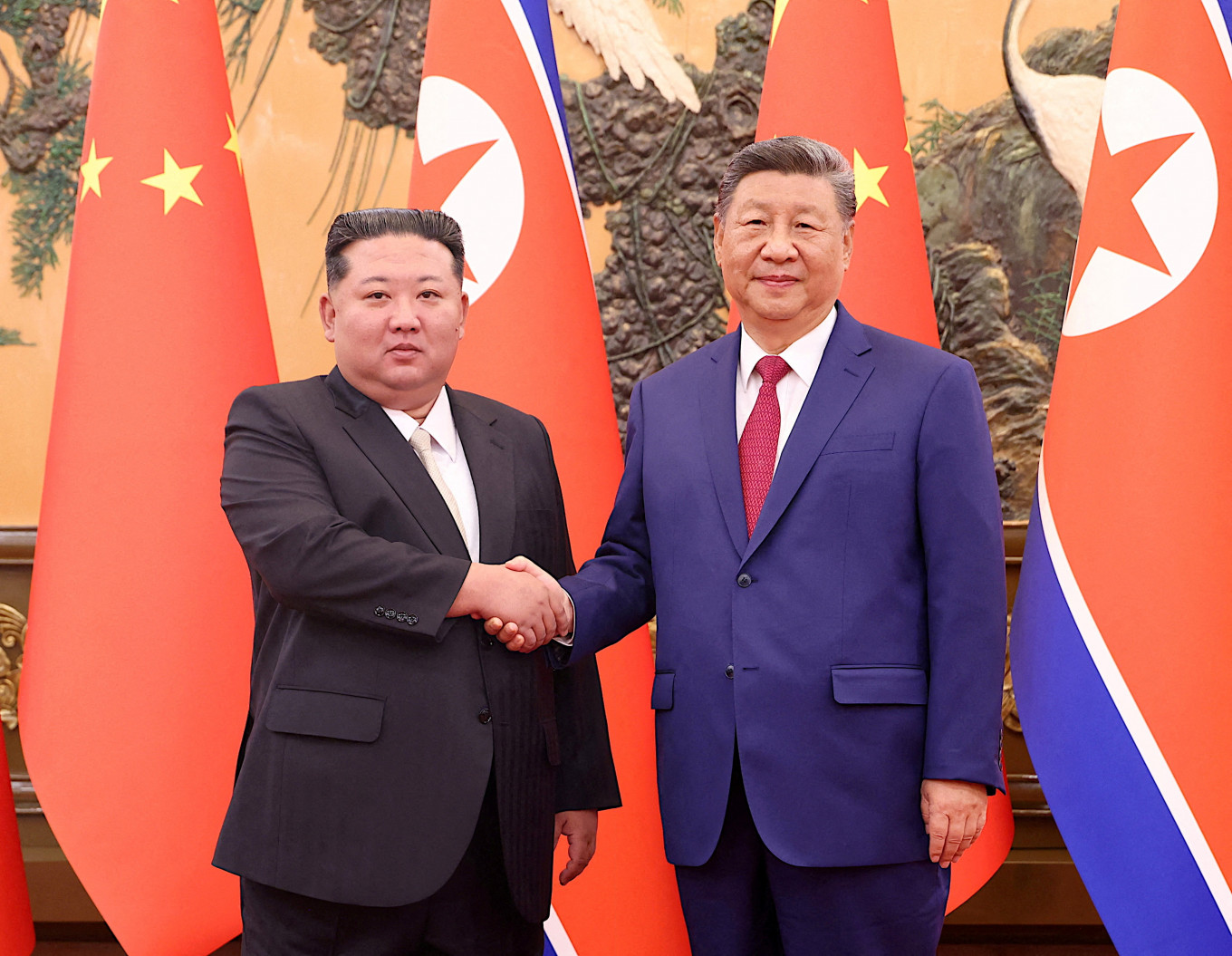 Chinese President Xi Jinping and Democratic People's Republic of Korea (DPRK) leader Kim Jong Un shake hands at the Great Hall of the People in Beijing, China September 4, 2025. 