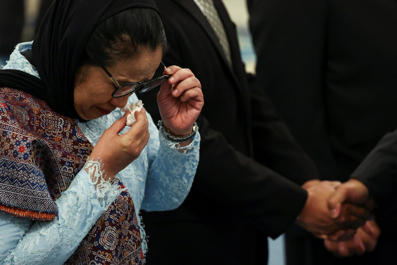 In this file photo, Nanik Sudaryati Deyang, head of National Nutrition Agency (BGN), wipes her tears during her inauguration at the State Palace in Jakarta, Indonesia, June 8, 2026. 