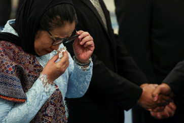 In this file photo, Nanik Sudaryati Deyang, head of National Nutrition Agency (BGN), wipes her tears during her inauguration at the State Palace in Jakarta, Indonesia, June 8, 2026. 