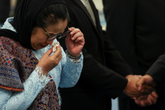 In this file photo, Nanik Sudaryati Deyang, head of National Nutrition Agency (BGN), wipes her tears during her inauguration at the State Palace in Jakarta, Indonesia, June 8, 2026. 