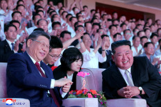 Chinese President Xi Jinping sits next to North Korean leader Kim Jong Un as he attends a performance at the Pyongyang Indoor Stadium, during his state visit, in Pyongyang, North Korea, June 8, 2026.   