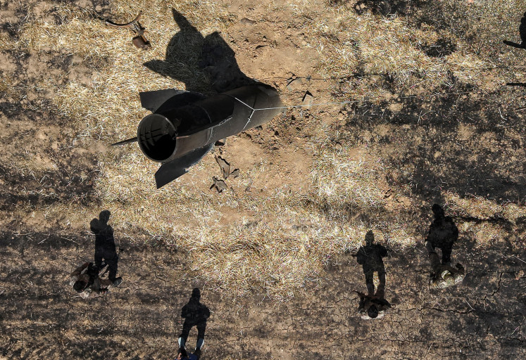 A drone view shows members of military engineering teams working at the site where, according to local authorities, an Iranian missile fell in the countryside near Damascus, Syria, June 9, 2026.