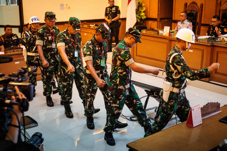 Four Indonesian Military (TNI) personnel found guilty of throwing acid at human rights activist Andrie Yunus leave after their verdict hearing on June 10 at the Jakarta Military Court.