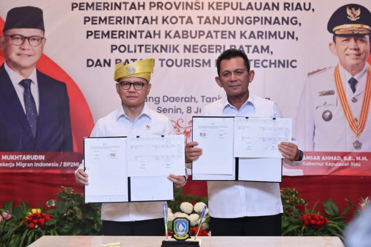 Migrant Workers Protection Minister Mukhtarudin (left) and Riau Islands Governor Ansar Ahmad hold the documents after signing a Memorandum of Understanding on strengthening the upstream sector through vocational education in Tanjung Pinang on June 8, 2026. The MoU involves also&nbsp;Tanjung Pinang city administration, Karimun regency administration, Batam State Polytechnic and Batam Tourism Polytechnic.