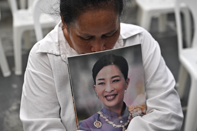 A mourner weeps while holding a photo of Thai princess Bajrakitiyabha Mahidol in front of Chulalongkorn Hospital in Bangkok on June 12, 2026. Thai Princess Bajrakitiyabha Mahidol, the king's eldest daughter, has died aged 47, the royal palace announced on June 12, more than three years after she was hospitalized following a sudden illness.