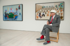 Artist David Hockney poses for photographers in front of his artworks &ldquo;Card Players #1&ldquo; (left) and &ldquo;The Chairs&ldquo; at a press preview of his new exhibition entitled &ldquo;Painting and Photography&ldquo; in central London, on May 14, 2015. 