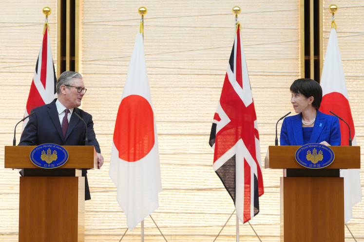 Britain's Prime Minister Keir Starmer (left) and Japanese Prime Minister Sanae Takaichi take part in a joint press conference after their bilateral meeting at the Prime Minister's Office in Tokyo on January 31, 2026.