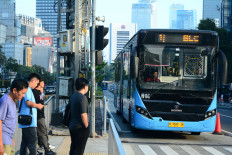 A Transjakarta bus approaches a pedestrian crossing near the Tosari bus stop in the MH Thamrin area of Central Jakarta, on June 14, 2026.