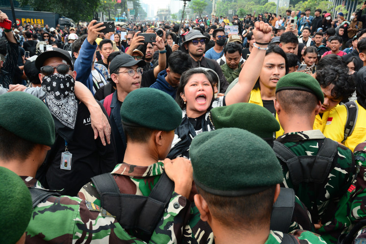 Protesters react after Indonesian military personnel blocked a road during a student protest on June 12 in Jakarta. Demonstrators criticized state budget spending, fuel prices, the free meals program, and the expanded role of the military in civilian affairs.