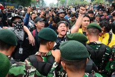 Protesters react after Indonesian military personnel blocked a road during a student protest on June 12 in Jakarta. Demonstrators criticized state budget spending, fuel prices, the free meals program, and the expanded role of the military in civilian affairs.