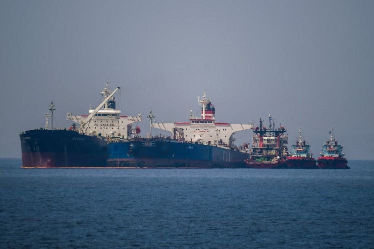 The Liberian-flagged oil tanker Ice Energy (left) transfers crude oil from the Russian-flagged oil tanker Lana (right) (former Pegas), off the shore of Karystos, on the Island of Evia, on May 29, 2022. 