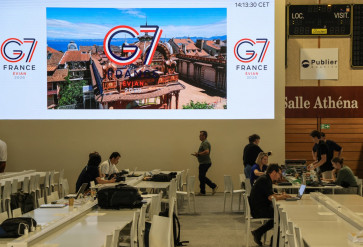 Journalists work at the G7's international press center a day ahead of the event start, in Publier, near Evian, eastern France, on June 14, 2026. A G7 summit is set to take place June 15 to 17 in the French town of Evian-les-Bains near Switzerland and it will be attended by country leaders as well as the EU's foreign policy chief and ministers from Brazil, Canada, the United Arab Emirates and Turkey.