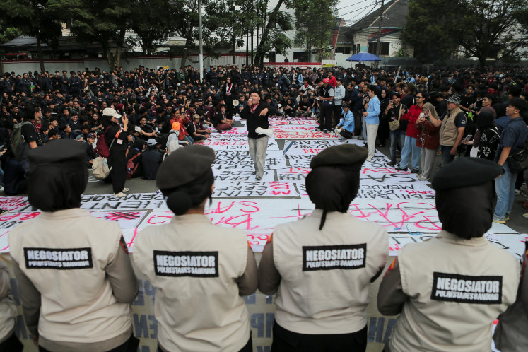 University students take part in a protest on Monday against government policies, including state budget spending, fuel price hikes, the free nutritious meal program and expanded military roles in civilian affairs, outside the West Java Regional Representative Council building in Bandung, West Java. 