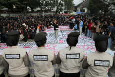 University students take part in a protest on Monday against government policies, including state budget spending, fuel price hikes, the free nutritious meal program and expanded military roles in civilian affairs, outside the West Java Regional Representative Council building in Bandung, West Java. 