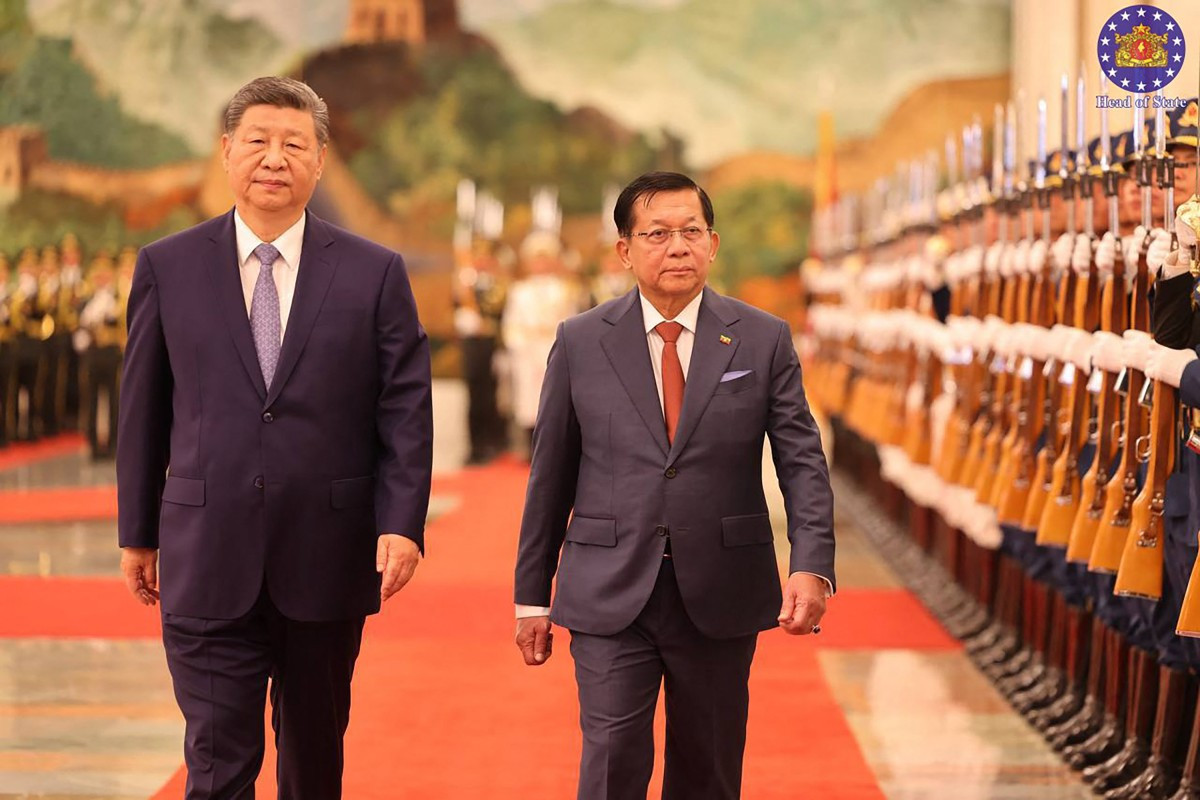 This handout picture taken and released on June 16, 2026 by Myanmar's Presidential Press and Information Bureau shows Myanmar's President Min Aung Hlaing (right) and China's President Xi Jinping inspecting a guard of honour during a welcoming ceremony at the Great Hall of the People in Beijing.