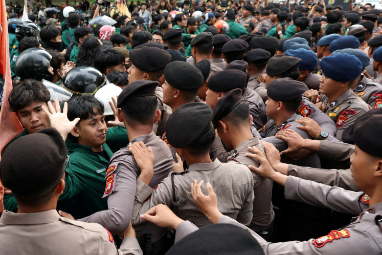 University students clash with police during a protest against government policies, including state budget spending, the free meals program and expanded military roles in civilian affairs, on June 15 in Jakarta.