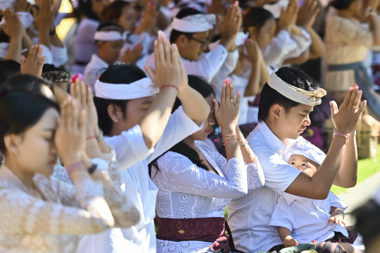 Balinese Hindus pray during Galungan celebrations at Jagatnatha Temple in Denpasar, Bali, on June 17, 2026. Hindus across Bali gather at temples to mark Galungan, a religious holiday celebrating the victory of good (Dharma) over evil (Adharma).