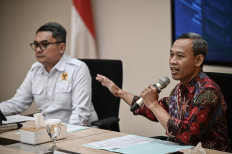 Subcommission Coordinator for Human Rights Enforcement Pramono Ubaid Tanthowi, right, and Commissioner for Research and Studies Uli Parulian Sihombing, left, speak during a press conference on the presentation of preliminary findings and recommendations regarding the implementation and oversight of the Free Nutritious Meals (MBG) program at the Komnas HAM office in Jakarta, Indonesia, Monday, June 15, 2026. Komnas HAM called for a comprehensive evaluation of the MBG program, citing concerns including an overly broad target beneficiary group that could affect program quality, as well as issues of transparency and oversight that require improvement. 